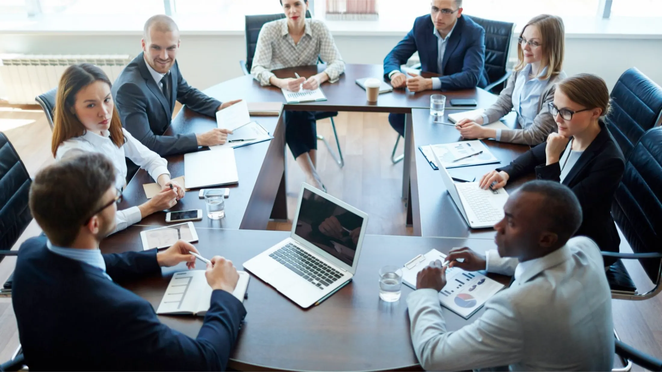 Consulting team reviewing documents on a laptop